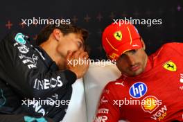 (L to R): George Russell (GBR) Mercedes AMG F1 and Carlos Sainz Jr (ESP) Ferrari in the post race FIA Press Conference. 30.06.2024. Formula 1 World Championship, Rd 11, Austrian Grand Prix, Spielberg, Austria, Race Day.