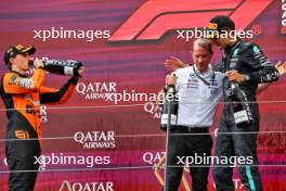 (L to R): Oscar Piastri (AUS) McLaren celebrates on the podium with Marcus Dudley (GBR) Mercedes AMG F1 Race Engineer and race winner George Russell (GBR) Mercedes AMG F1. 30.06.2024. Formula 1 World Championship, Rd 11, Austrian Grand Prix, Spielberg, Austria, Race Day.