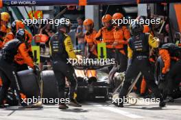 Lando Norris (GBR) McLaren MCL38 makes a pit stop with a puncture after contact with Max Verstappen (NLD) Red Bull Racing RB20. 30.06.2024. Formula 1 World Championship, Rd 11, Austrian Grand Prix, Spielberg, Austria, Race Day.