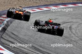 Oscar Piastri (AUS) McLaren MCL38 leads Sergio Perez (MEX) Red Bull Racing RB20. 30.06.2024. Formula 1 World Championship, Rd 11, Austrian Grand Prix, Spielberg, Austria, Race Day.