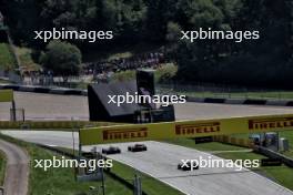 Carlos Sainz Jr (ESP) Ferrari SF-24 and George Russell (GBR) Mercedes AMG F1 W15. 29.06.2024. Formula 1 World Championship, Rd 11, Austrian Grand Prix, Spielberg, Austria, Sprint and Qualifying Day.
