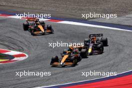 Lando Norris (GBR) McLaren MCL38 and Max Verstappen (NLD) Red Bull Racing RB20 battle for position. 29.06.2024. Formula 1 World Championship, Rd 11, Austrian Grand Prix, Spielberg, Austria, Sprint and Qualifying Day.
