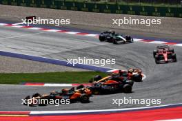 Lando Norris (GBR) McLaren MCL38 and Max Verstappen (NLD) Red Bull Racing RB20 battle for position. 29.06.2024. Formula 1 World Championship, Rd 11, Austrian Grand Prix, Spielberg, Austria, Sprint and Qualifying Day.