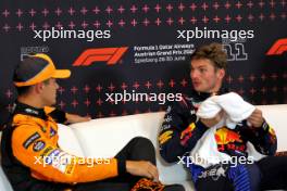 (L to R): Lando Norris (GBR) McLaren and Max Verstappen (NLD) Red Bull Racing in the post qualifying FIA Press Conference. 29.06.2024. Formula 1 World Championship, Rd 11, Austrian Grand Prix, Spielberg, Austria, Sprint and Qualifying Day.