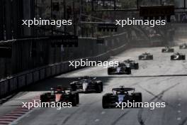 Lando Norris (GBR) McLaren MCL38 and Yuki Tsunoda (JPN) RB VCARB 01 battle for position. 15.09.2024. Formula 1 World Championship, Rd 17, Azerbaijan Grand Prix, Baku Street Circuit, Azerbaijan, Race Day.