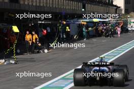 Pierre Gasly (FRA) Alpine F1 Team A524 in the pit lane for a pit stop with McLaren mechanics walking down to Parc Ferme. 15.09.2024. Formula 1 World Championship, Rd 17, Azerbaijan Grand Prix, Baku Street Circuit, Azerbaijan, Race Day.