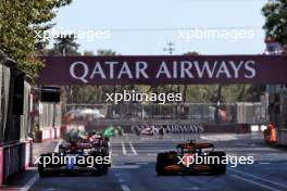 Yuki Tsunoda (JPN) RB VCARB 01 and Lando Norris (GBR) McLaren MCL38 battle for position. 15.09.2024. Formula 1 World Championship, Rd 17, Azerbaijan Grand Prix, Baku Street Circuit, Azerbaijan, Race Day.