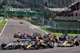 Lewis Hamilton (GBR) Mercedes AMG F1 W15 and Sergio Perez (MEX) Red Bull Racing RB20 at the start of the race. 28.07.2024. Formula 1 World Championship, Rd 14, Belgian Grand Prix, Spa Francorchamps, Belgium, Race Day.