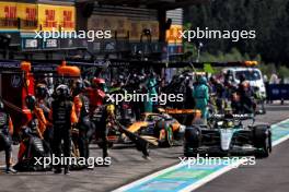 Lewis Hamilton (GBR) Mercedes AMG F1 W15 makes a pit stop ahead of Oscar Piastri (AUS) McLaren MCL38. 28.07.2024. Formula 1 World Championship, Rd 14, Belgian Grand Prix, Spa Francorchamps, Belgium, Race Day.