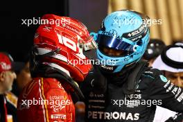 (L to R): Charles Leclerc (MON) Ferrari in qualifying parc ferme with George Russell (GBR) Mercedes AMG F1. 01.03.2024. Formula 1 World Championship, Rd 1, Bahrain Grand Prix, Sakhir, Bahrain, Qualifying Day.