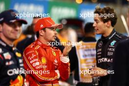 (L to R): Charles Leclerc (MON) Ferrari with George Russell (GBR) Mercedes AMG F1 in qualifying parc ferme. 01.03.2024. Formula 1 World Championship, Rd 1, Bahrain Grand Prix, Sakhir, Bahrain, Qualifying Day.