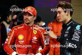 (L to R): Charles Leclerc (MON) Ferrari with George Russell (GBR) Mercedes AMG F1 in qualifying parc ferme. 01.03.2024. Formula 1 World Championship, Rd 1, Bahrain Grand Prix, Sakhir, Bahrain, Qualifying Day.