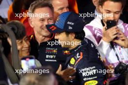 Sergio Perez (MEX) Red Bull Racing celebrates his second position in parc ferme with Chalerm Yoovidhya (THA) Red Bull Racing Co-Owner and Christian Horner (GBR) Red Bull Racing Team Principal. 02.03.2024. Formula 1 World Championship, Rd 1, Bahrain Grand Prix, Sakhir, Bahrain, Race Day.