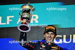 Sergio Perez (MEX) Red Bull Racing celebrates his second on the podium. 02.03.2024. Formula 1 World Championship, Rd 1, Bahrain Grand Prix, Sakhir, Bahrain, Race Day.