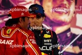 (L to R): Carlos Sainz Jr (ESP) Ferrari and Sergio Perez (MEX) Red Bull Racing in parc ferme. 02.03.2024. Formula 1 World Championship, Rd 1, Bahrain Grand Prix, Sakhir, Bahrain, Race Day.