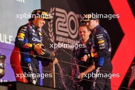 Race winner Max Verstappen (NLD) Red Bull Racing celebrates on the podium with second placed team mate Sergio Perez (MEX) Red Bull Racing. 02.03.2024. Formula 1 World Championship, Rd 1, Bahrain Grand Prix, Sakhir, Bahrain, Race Day.