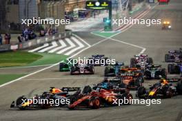 Max Verstappen (NLD) Red Bull Racing RB20 leads Charles Leclerc (MON) Ferrari SF-24 at the start of the race. 02.03.2024. Formula 1 World Championship, Rd 1, Bahrain Grand Prix, Sakhir, Bahrain, Race Day.