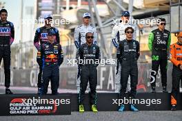 Drivers' Class of 2024 group photograph (L to R): Max Verstappen (NLD) Red Bull Racing; Lewis Hamilton (GBR) Mercedes AMG F1; and George Russell (GBR) Mercedes AMG F1. 02.03.2024. Formula 1 World Championship, Rd 1, Bahrain Grand Prix, Sakhir, Bahrain, Race Day.