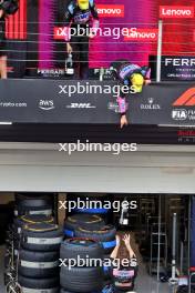 Esteban Ocon (FRA) Alpine F1 Team and Pierre Gasly (FRA) Alpine F1 Team deop their champagne to the team on the podium. 03.11.2024. Formula 1 World Championship, Rd 21, Brazilian Grand Prix, Sao Paulo, Brazil, Race Day.