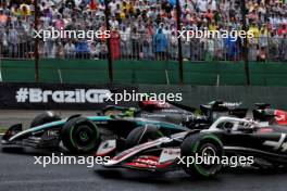 Lewis Hamilton (GBR) Mercedes AMG F1 W15 and Oliver Bearman (GBR) Haas VF-24 Reserve Driver battle for position. 03.11.2024. Formula 1 World Championship, Rd 21, Brazilian Grand Prix, Sao Paulo, Brazil, Race Day.