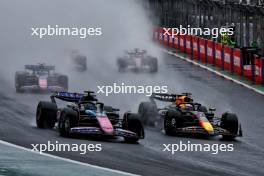 Esteban Ocon (FRA) Alpine F1 Team A524 and Max Verstappen (NLD) Red Bull Racing RB20 battle for the lead of the race. 03.11.2024. Formula 1 World Championship, Rd 21, Brazilian Grand Prix, Sao Paulo, Brazil, Race Day.