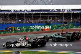 Lewis Hamilton (GBR) Mercedes AMG F1 W15 and Oliver Bearman (GBR) Haas VF-24 Reserve Driver battle for position. 03.11.2024. Formula 1 World Championship, Rd 21, Brazilian Grand Prix, Sao Paulo, Brazil, Race Day.