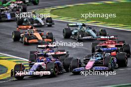 (L to R): Yuki Tsunoda (JPN) RB VCARB 01 and Esteban Ocon (FRA) Alpine F1 Team A524 at the start of the race. 03.11.2024. Formula 1 World Championship, Rd 21, Brazilian Grand Prix, Sao Paulo, Brazil, Race Day.