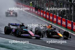 Esteban Ocon (FRA) Alpine F1 Team A524 and Max Verstappen (NLD) Red Bull Racing RB20 battle for the lead of the race. 03.11.2024. Formula 1 World Championship, Rd 21, Brazilian Grand Prix, Sao Paulo, Brazil, Race Day.