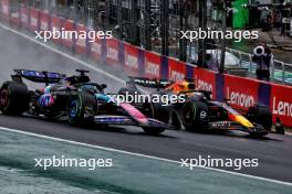 Esteban Ocon (FRA) Alpine F1 Team A524 and Max Verstappen (NLD) Red Bull Racing RB20 battle for the lead of the race. 03.11.2024. Formula 1 World Championship, Rd 21, Brazilian Grand Prix, Sao Paulo, Brazil, Race Day.