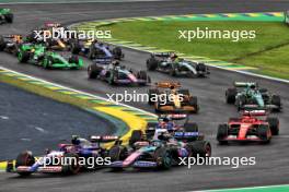 Yuki Tsunoda (JPN) RB VCARB 01 and Esteban Ocon (FRA) Alpine F1 Team A524 at the start of the race. 03.11.2024. Formula 1 World Championship, Rd 21, Brazilian Grand Prix, Sao Paulo, Brazil, Race Day.