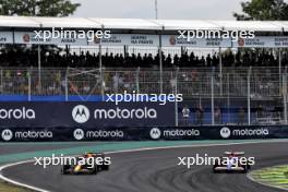 Sergio Perez (MEX) Red Bull Racing RB20 and Liam Lawson (NZL) RB VCARB 01 battle for position. 02.11.2024. Formula 1 World Championship, Rd 21, Brazilian Grand Prix, Sao Paulo, Brazil, Sprint and Qualifying Day.