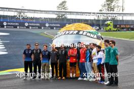 F1 drivers lined up at the Senna S with a tribute helmet of Ayrton Senna made from recycled materials. 31.10.2024. Formula 1 World Championship, Rd 21, Brazilian Grand Prix, Sao Paulo, Brazil, Preparation Day.