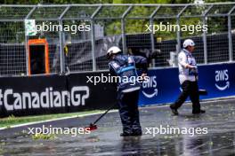 Circuit atmosphere - a marshal sweeps the circuit of debris following a thunderstorm. 07.06.2024. Formula 1 World Championship, Rd 9, Canadian Grand Prix, Montreal, Canada, Practice Day.