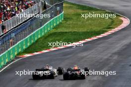 Nico Hulkenberg (GER) Haas VF-24 and Sergio Perez (MEX) Red Bull Racing RB20 battle for position. 09.06.2024. Formula 1 World Championship, Rd 9, Canadian Grand Prix, Montreal, Canada, Race Day.