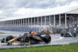 Max Verstappen (NLD) Red Bull Racing RB20 leaves the pits ahead of George Russell (GBR) Mercedes AMG F1 W15 and Oscar Piastri (AUS) McLaren MCL38. 09.06.2024. Formula 1 World Championship, Rd 9, Canadian Grand Prix, Montreal, Canada, Race Day.