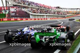 Zhou Guanyu (CHN) Sauber C44 and Daniel Ricciardo (AUS) RB VCARB 01 leave the pits. 19.04.2024. Formula 1 World Championship, Rd 5, Chinese Grand Prix, Shanghai, China, Sprint Qualifying Day.