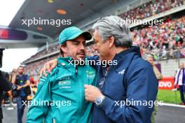 (L to R): Fernando Alonso (ESP) Aston Martin F1 Team with Luca de Meo (ITA) Groupe Renault Chief Executive Officer on the grid. 21.04.2024. Formula 1 World Championship, Rd 5, Chinese Grand Prix, Shanghai, China, Race Day.