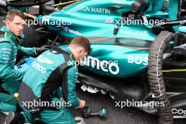 Aston Martin F1 Team mechanics perform repairs on the floor of Fernando Alonso (ESP) Aston Martin F1 Team AMR24 on the grid. 21.04.2024. Formula 1 World Championship, Rd 5, Chinese Grand Prix, Shanghai, China, Race Day.