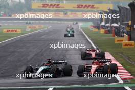 George Russell (GBR) Mercedes AMG F1 W15 and Charles Leclerc (MON) Ferrari SF-24 battle for position. 21.04.2024. Formula 1 World Championship, Rd 5, Chinese Grand Prix, Shanghai, China, Race Day.