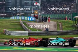 Carlos Sainz Jr (ESP) Ferrari SF-24 and Lance Stroll (CDN) Aston Martin F1 Team AMR24 battle for position. 21.04.2024. Formula 1 World Championship, Rd 5, Chinese Grand Prix, Shanghai, China, Race Day.
