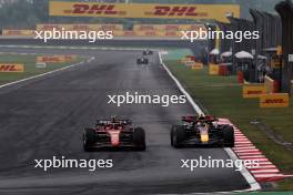 Carlos Sainz Jr (ESP) Ferrari SF-24 and Sergio Perez (MEX) Red Bull Racing RB20 battle for position. 21.04.2024. Formula 1 World Championship, Rd 5, Chinese Grand Prix, Shanghai, China, Race Day.
