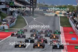 George Russell (GBR) Mercedes AMG F1 W15 leads Lando Norris (GBR) McLaren MCL38 and Max Verstappen (NLD) Red Bull Racing RB20 at the start of the race. 23.06.2024. Formula 1 World Championship, Rd 10, Spanish Grand Prix, Barcelona, Spain, Race Day.