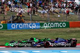 Zhou Guanyu (CHN) Sauber C44 and Yuki Tsunoda (JPN) RB VCARB 01 battle for position. 23.06.2024. Formula 1 World Championship, Rd 10, Spanish Grand Prix, Barcelona, Spain, Race Day.