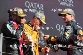 (L to R): Race winner Lewis Hamilton (GBR) Mercedes AMG F1 celebrates on the podium with Lando Norris (GBR) McLaren and Max Verstappen (NLD) Red Bull Racing. 07.07.2024. Formula 1 World Championship, Rd 12, British Grand Prix, Silverstone, England, Race Day.