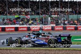 Alexander Albon (THA) Williams Racing FW46 and Esteban Ocon (FRA) Alpine F1 Team A524 battle for position. 07.07.2024. Formula 1 World Championship, Rd 12, British Grand Prix, Silverstone, England, Race Day.