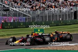 Lando Norris (GBR) McLaren MCL38 and Max Verstappen (NLD) Red Bull Racing RB20 battle for position. 07.07.2024. Formula 1 World Championship, Rd 12, British Grand Prix, Silverstone, England, Race Day.