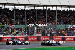 Alexander Albon (THA) Williams Racing FW46 and Esteban Ocon (FRA) Alpine F1 Team A524 battle for position. 07.07.2024. Formula 1 World Championship, Rd 12, British Grand Prix, Silverstone, England, Race Day.