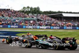 Oscar Piastri (AUS) McLaren MCL38 and Lewis Hamilton (GBR) Mercedes AMG F1 W15 battle for position. 07.07.2024. Formula 1 World Championship, Rd 12, British Grand Prix, Silverstone, England, Race Day.