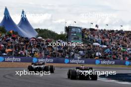 Lewis Hamilton (GBR) Mercedes AMG F1 W15 and George Russell (GBR) Mercedes AMG F1 W15 battle for position. 07.07.2024. Formula 1 World Championship, Rd 12, British Grand Prix, Silverstone, England, Race Day.