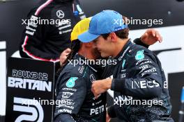 George Russell (GBR) Mercedes AMG F1 celebrates his pole position in qualifying parc ferme with second placed team mate Lewis Hamilton (GBR) Mercedes AMG F1. 06.07.2024. Formula 1 World Championship, Rd 12, British Grand Prix, Silverstone, England, Qualifying Day.